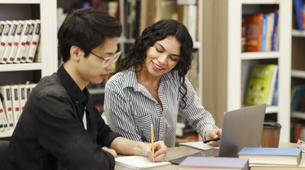 nuhs employee helping a student