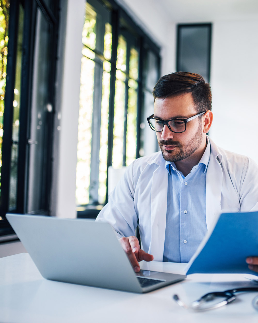 man on computer taking NUHS online ceu program