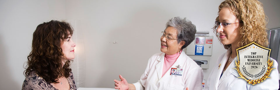 students and faculty working with patient