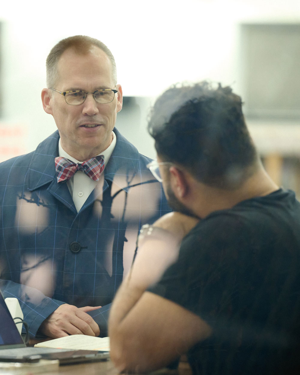 president sitting with student in the library