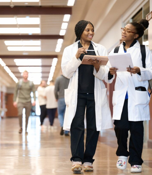 two female students walking down janse hallway