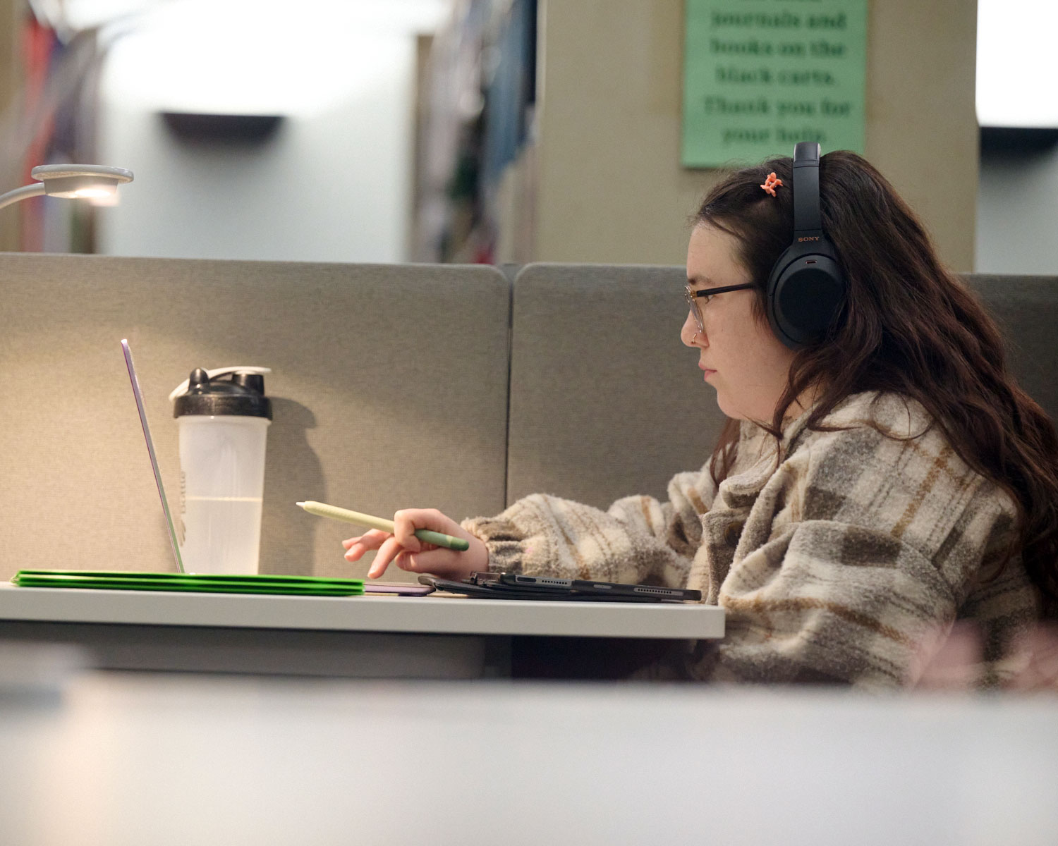 student watching videos on laptop in the library