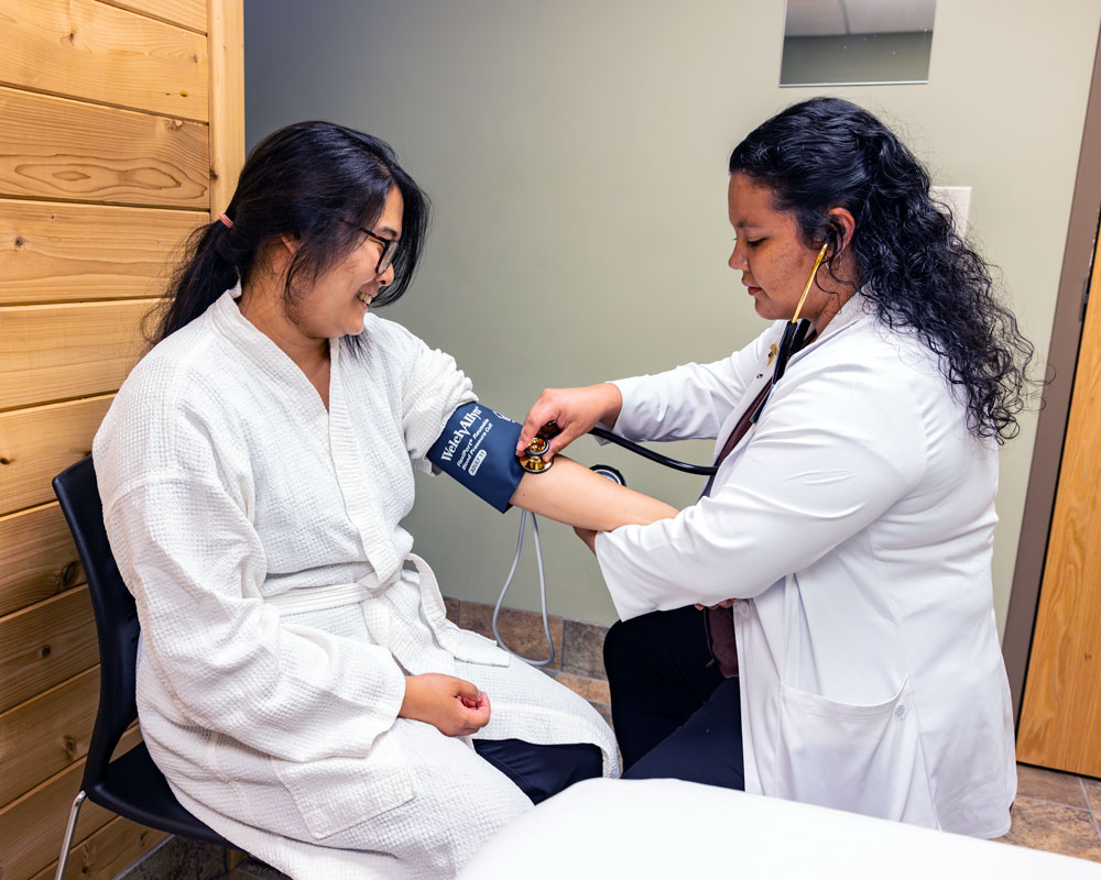 student blood pressure being taken in NUHS clinic