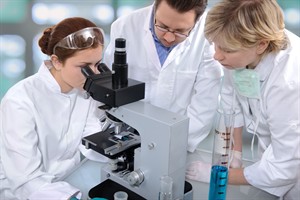 teachers and students with microscope