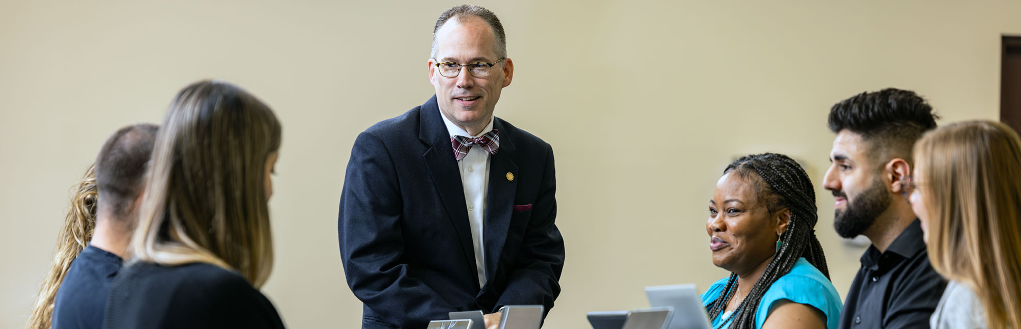 President Stiefel with students in a classroom